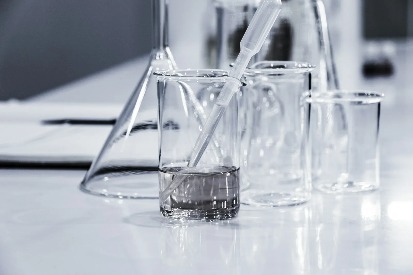 Glassware and pipettes on a laboratory bench